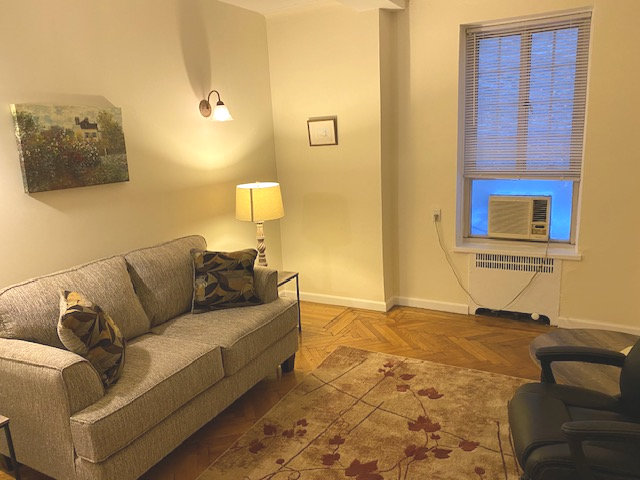 Cozy office living room with couch, chairs, and decor