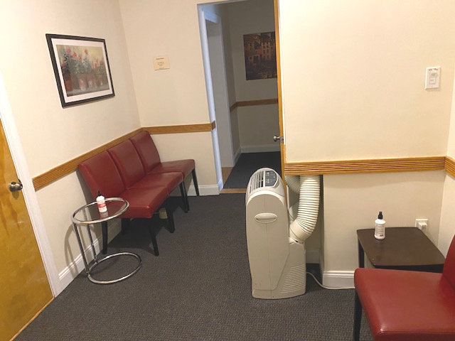 Spacious waiting room with chairs and a couch