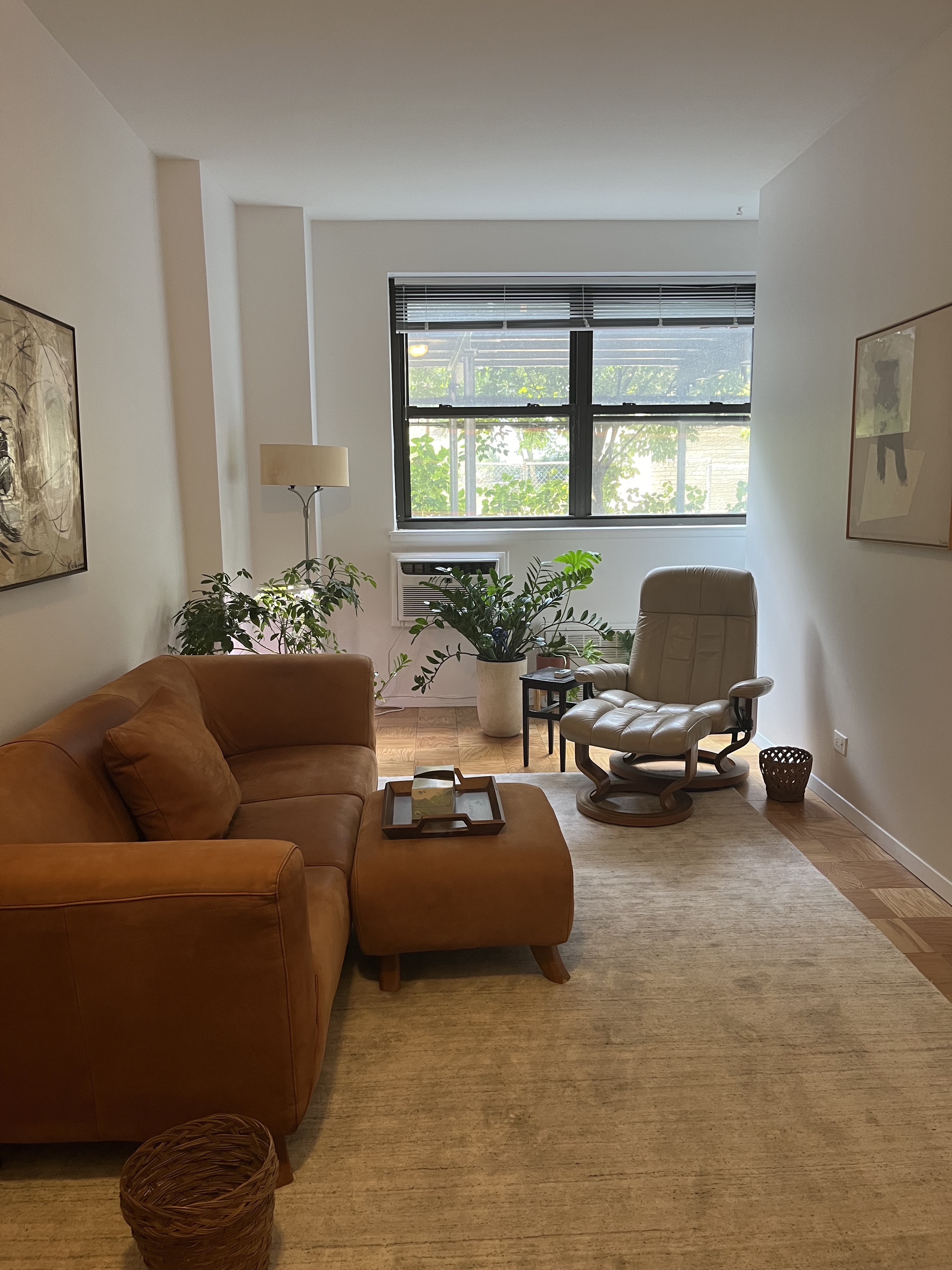 Office interior with couch, lamp, and wood flooring