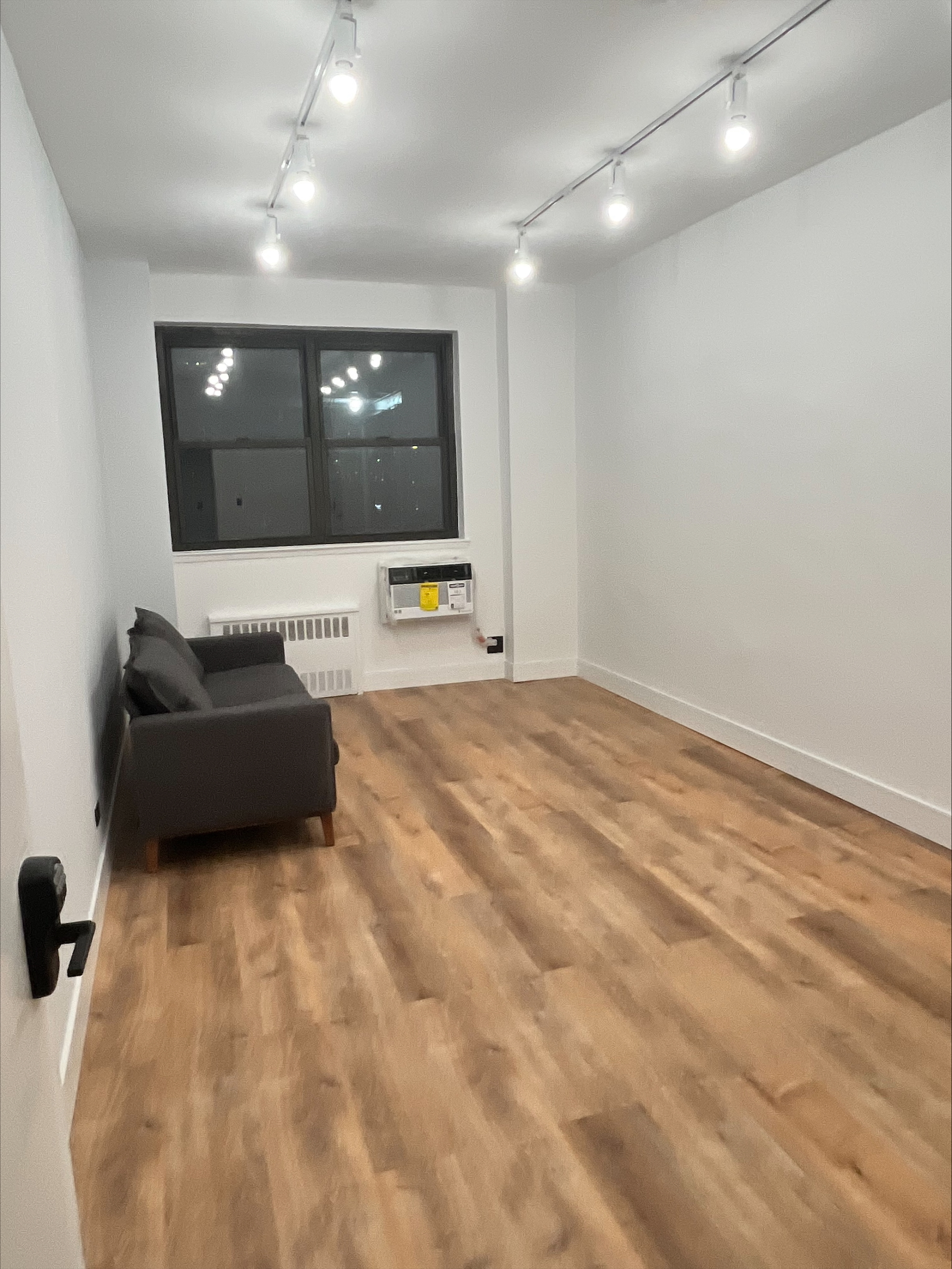 Interior office with hardwood flooring and comfortable couch