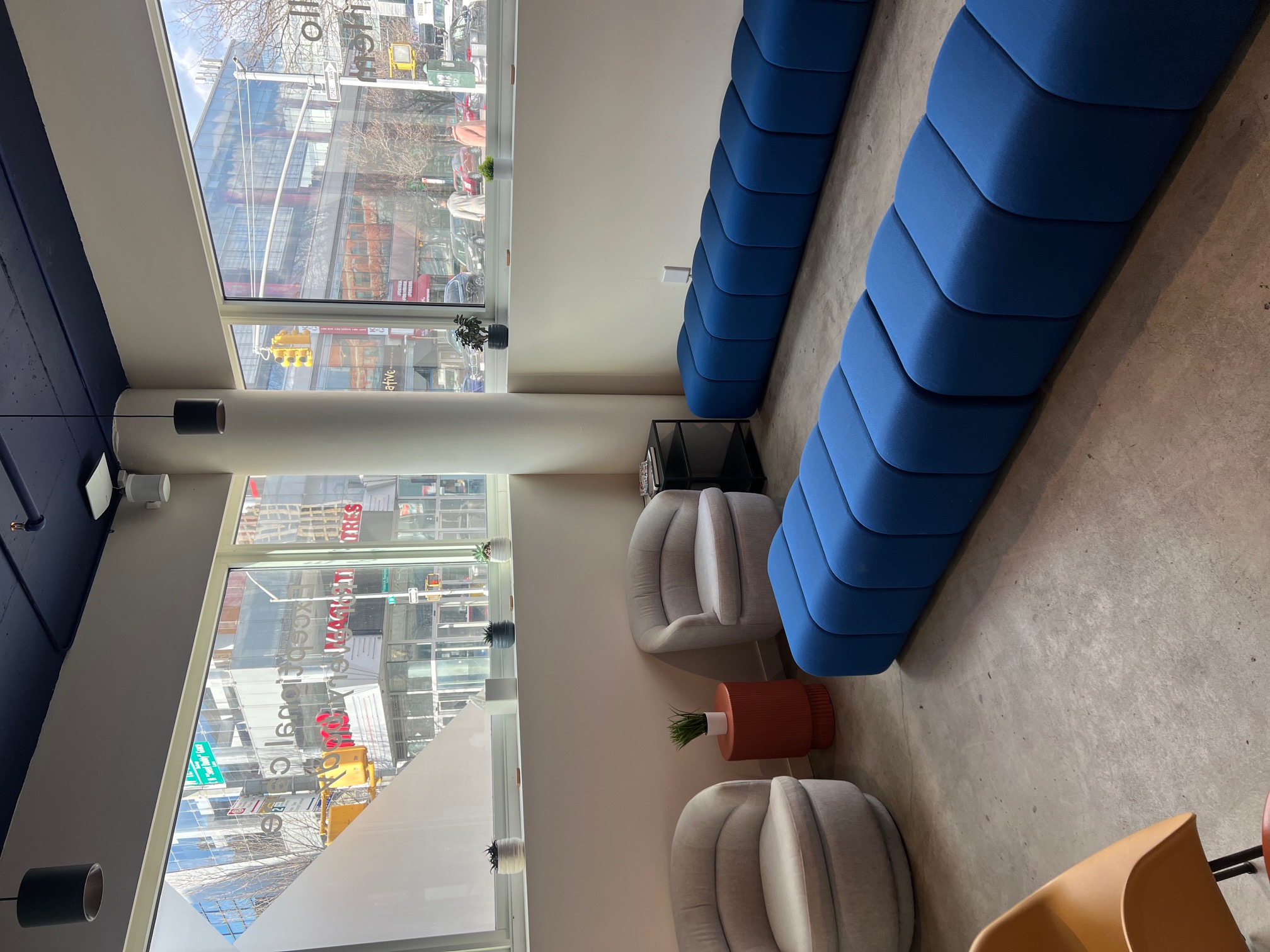 Lounge area with seating, plants, and a person