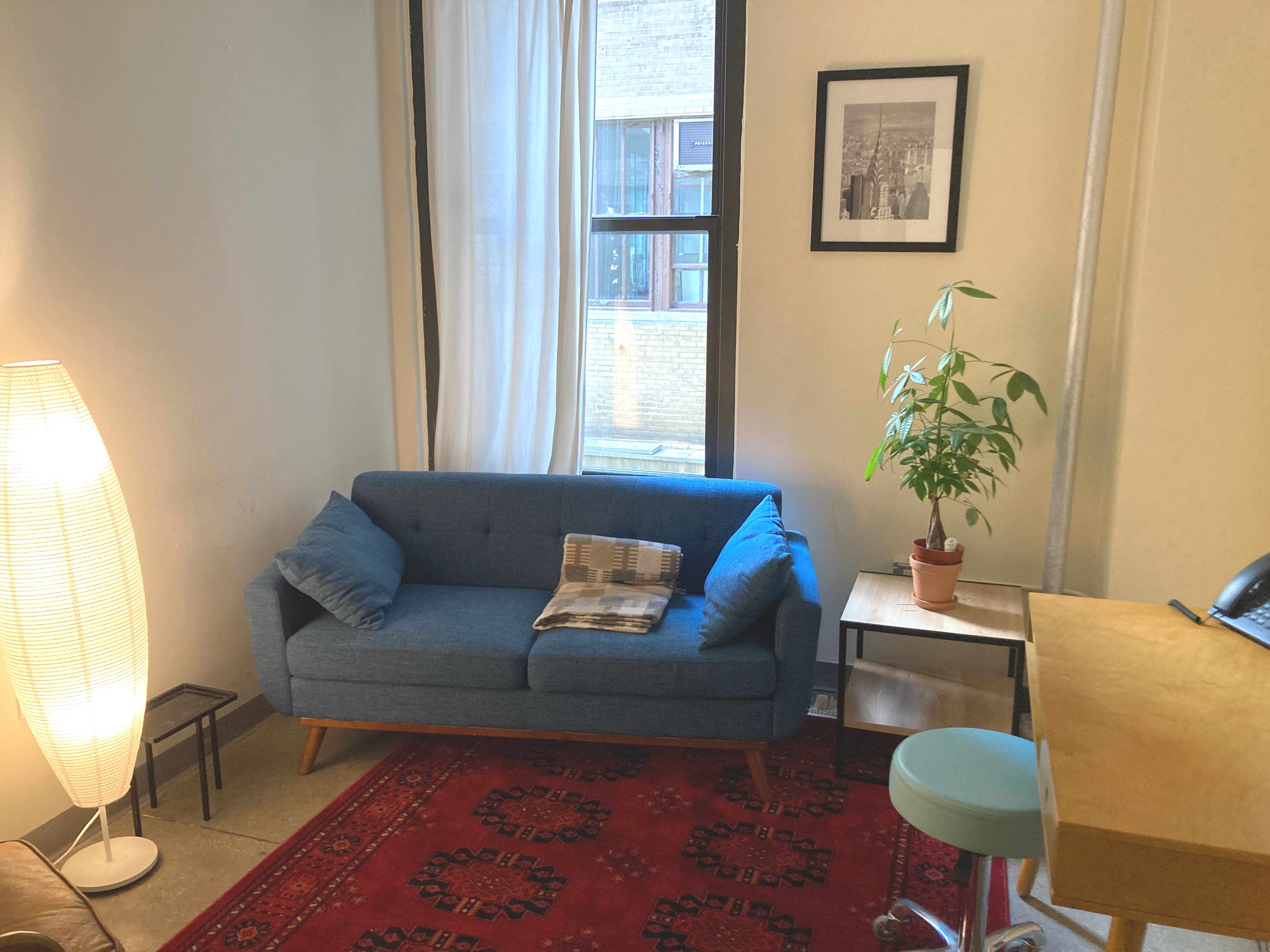 Office interior with a couch, desk, and decor elements