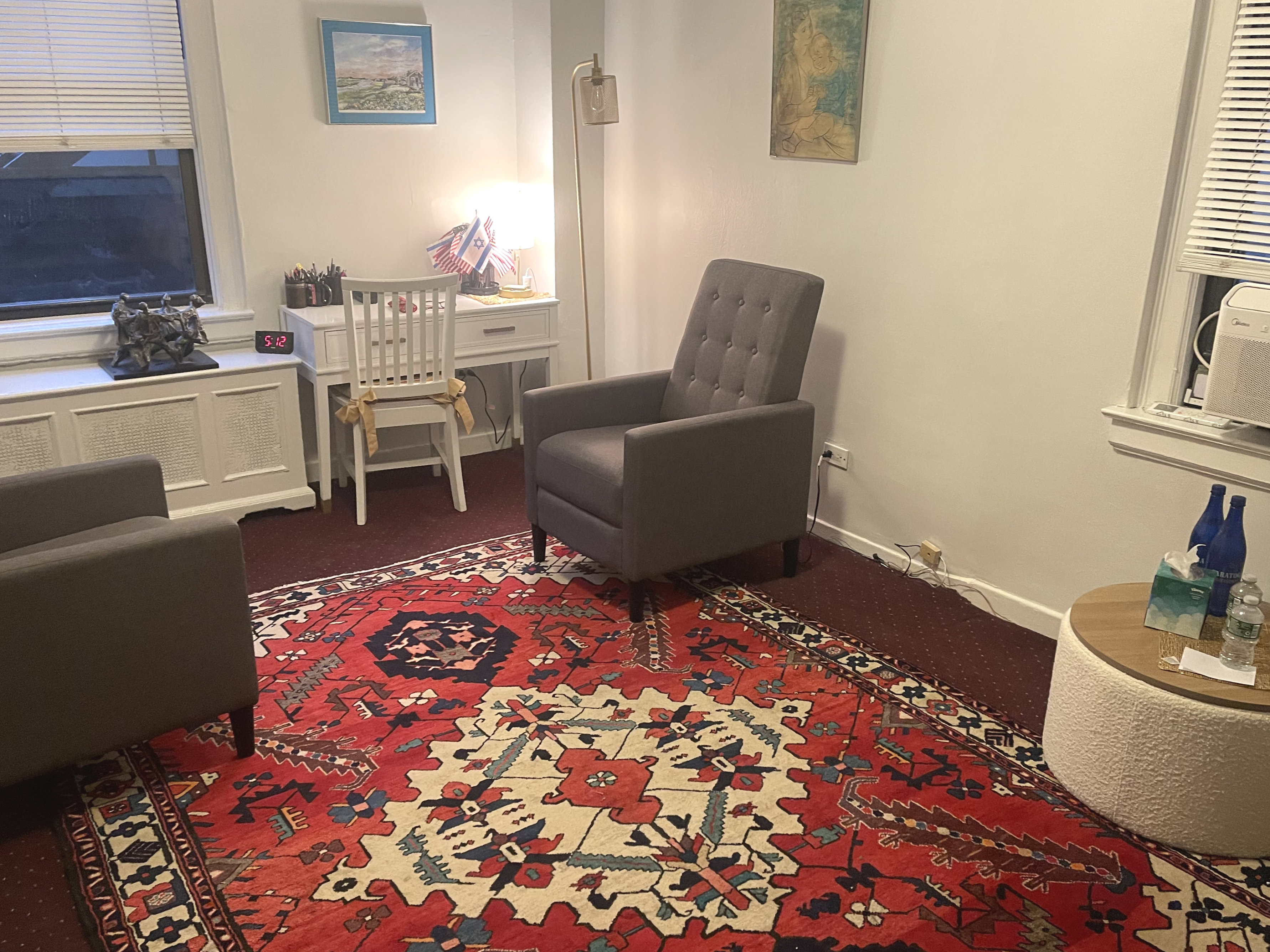 Living room style office with rug, chair, and couch