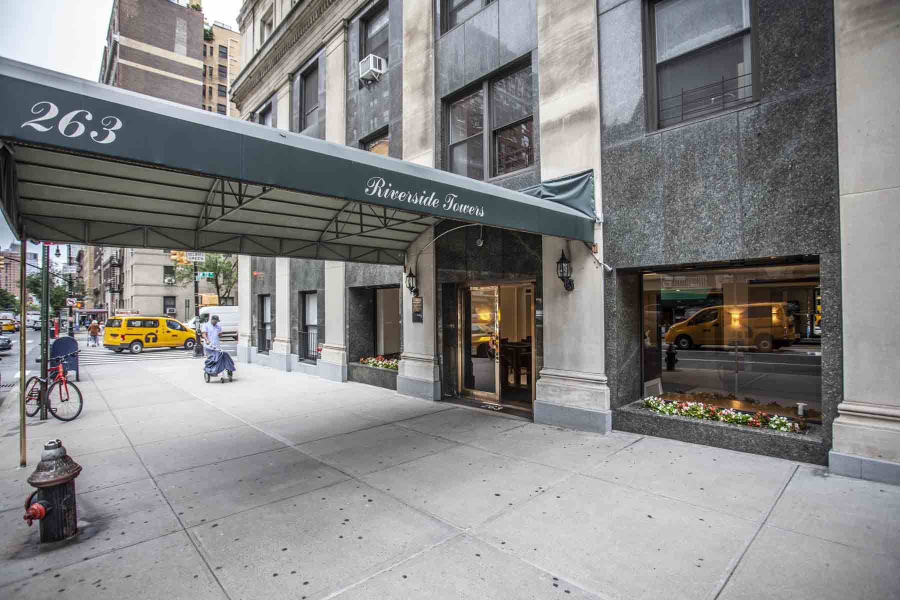 Busy urban street with cars and pedestrians near office building