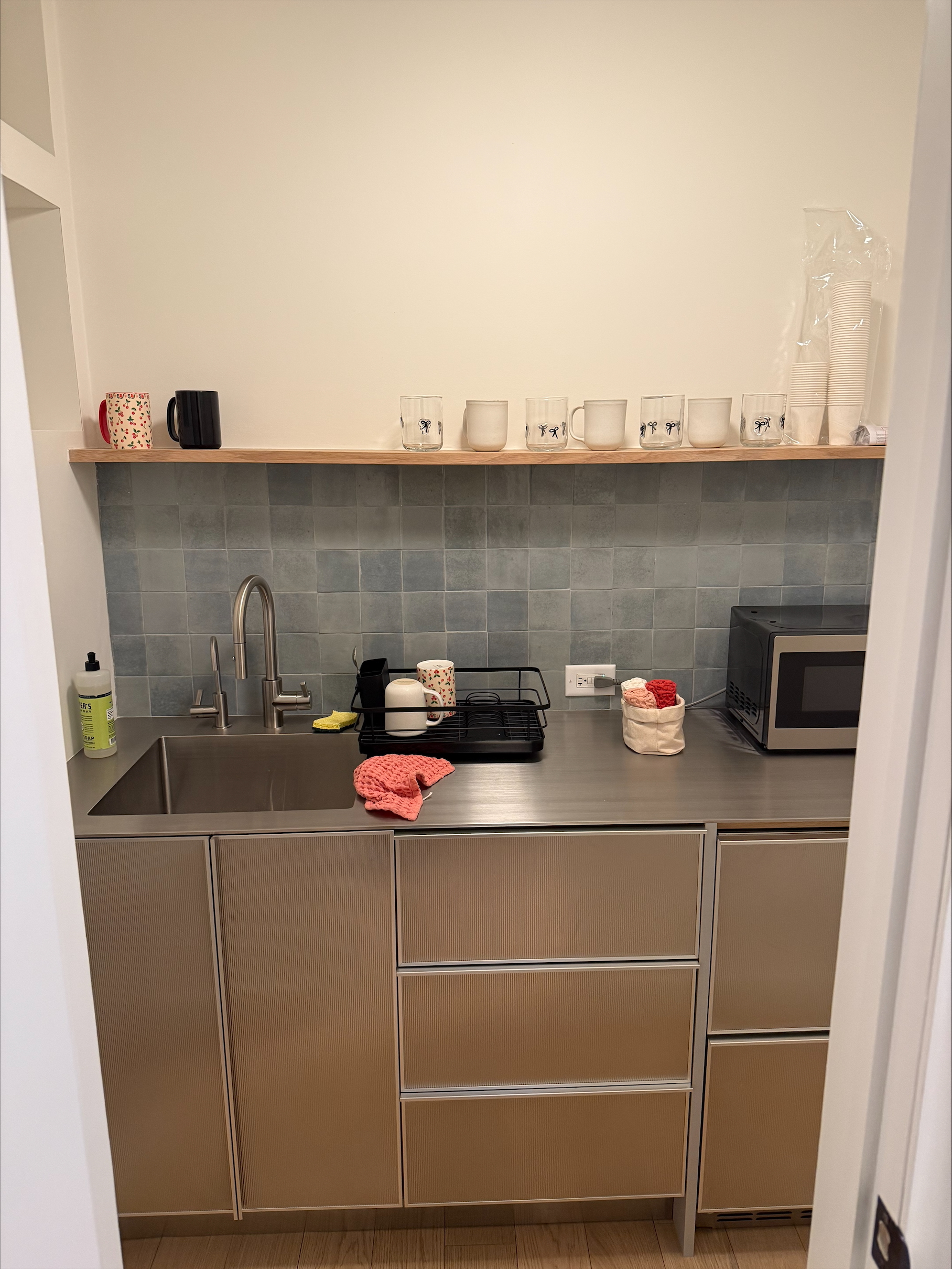 Office kitchen area with sink, microwave, and oven