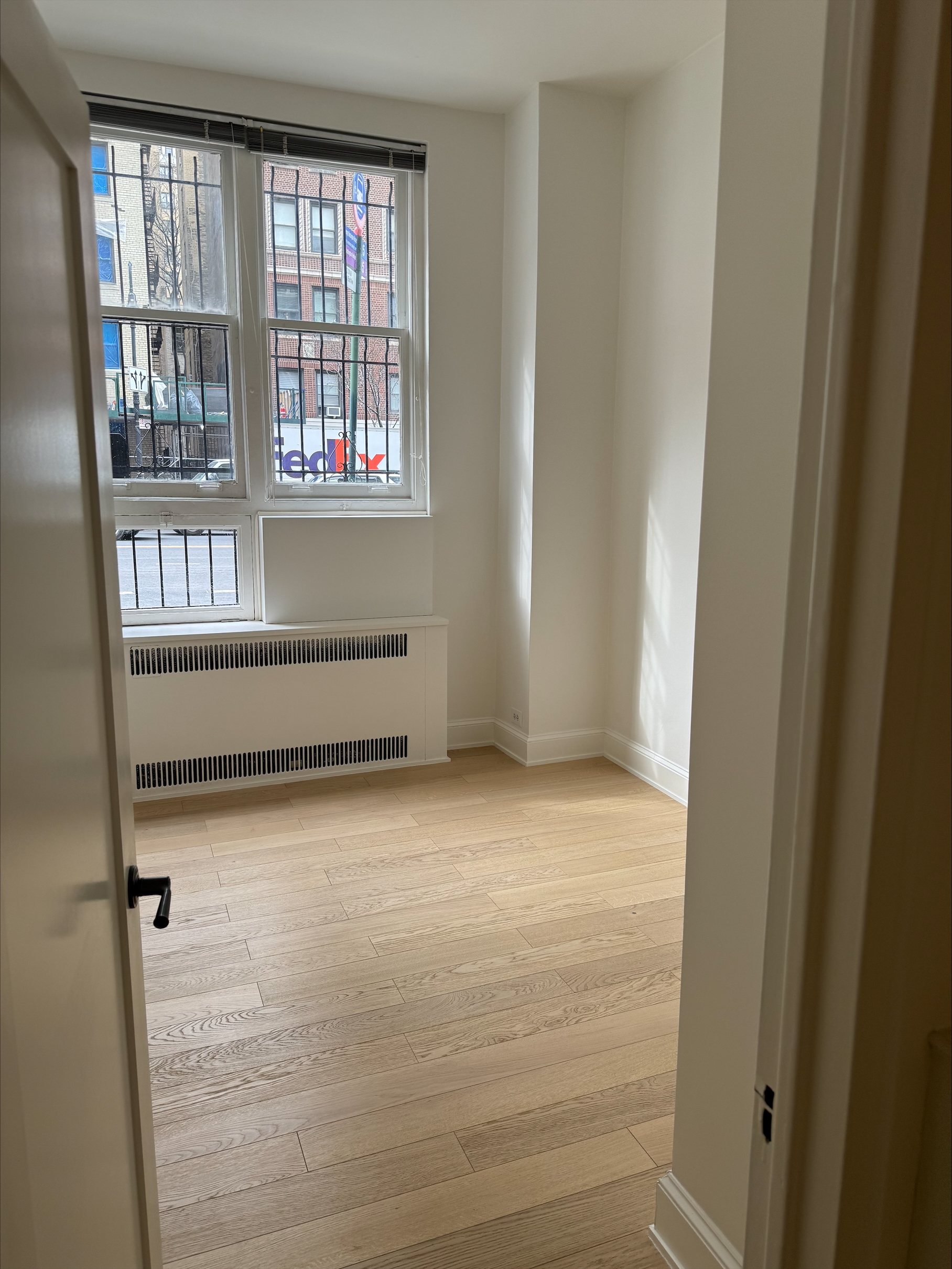Interior office space featuring hardwood flooring and windows