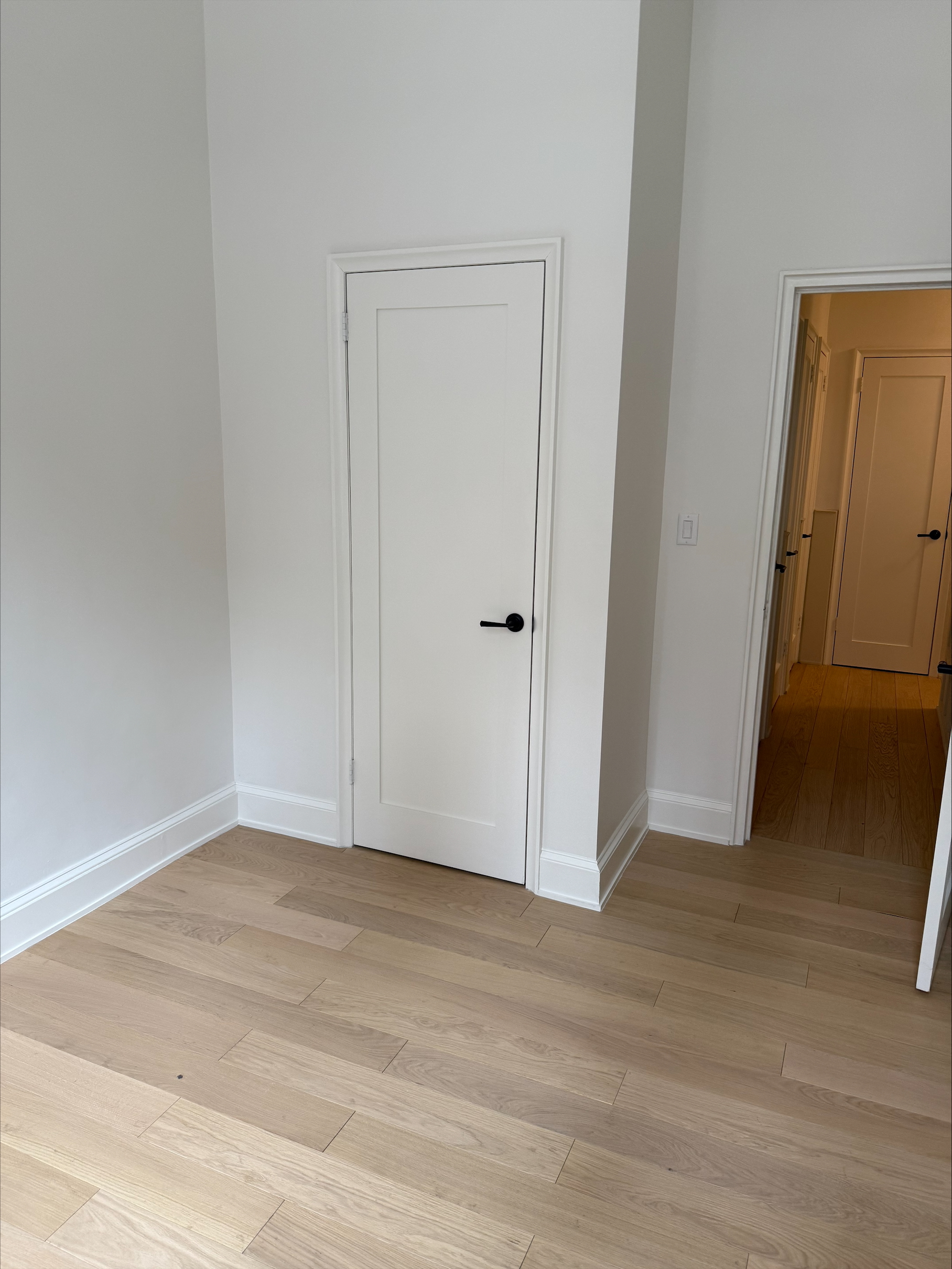 Interior office space with hardwood flooring and wood panels