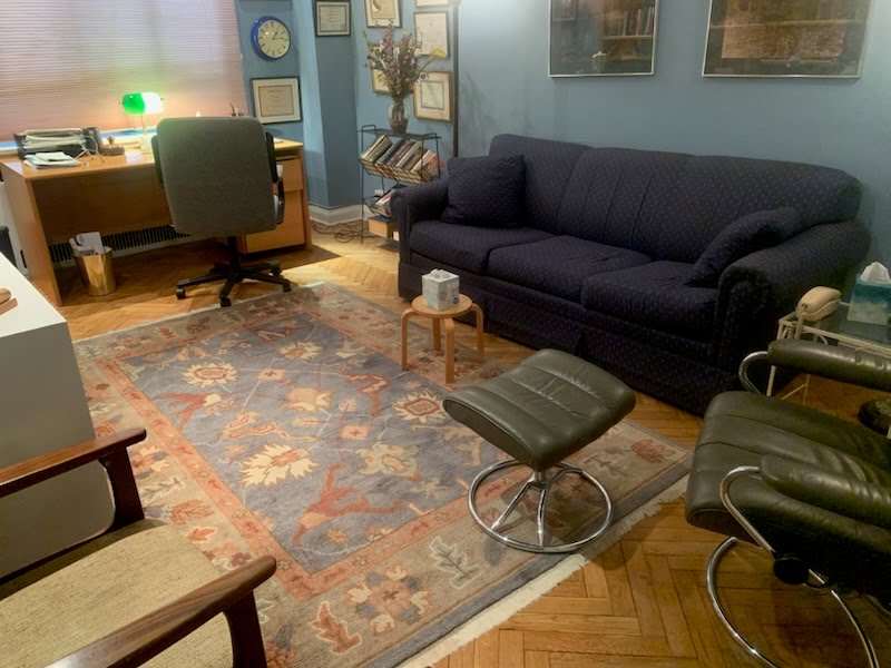 Cozy office living room with couch, table, and lamp
